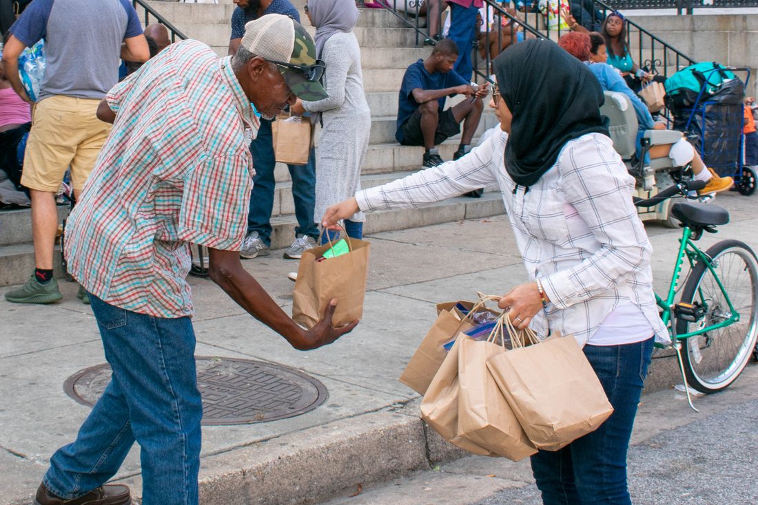 Act of Kindness Homeless Care Package Muslim Woman Hijabi Homeless Man at the steps of a Church